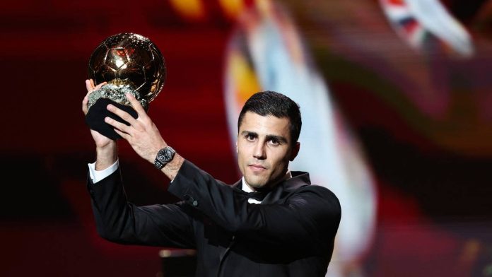 Manchester City's Spanish midfielder Rodri receives the Ballon d'Or award during the 2024 Ballon d'Or France Football award ceremony at the Theatre du Chatelet in Paris on October 28, 2024. (Photo by FRANCK FIFE / AFP)